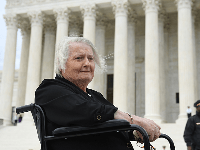 Transgender activist Aimee Stephens, sits in her wheelchair outside the US Supreme Court i