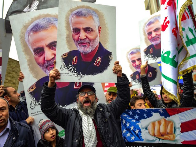 TOPSHOT - Protesters hold pictures of Iranian commander Qasem Soleimani, during a demonstration outside the US consulate in Istanbul, on January 5, 2020, two days after top Iranian commander Qasem Soleimani was killed by a US drone strike. - A US drone strike killed top Iranian commander Qasem Soleimani at Baghdad's international airport on January 3, dramatically heightening regional tensions and prompting arch enemy Tehran to vow "revenge". (Photo by Yasin AKGUL / AFP) (Photo by YASIN AKGUL/AFP via Getty Images)
