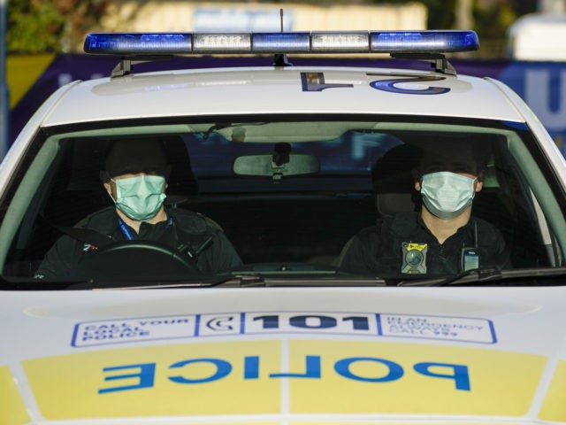 WOLVERHAMPTON, ENGLAND - APRIL 07: Police officers wear facial masks as they patrol during the pandemic lockdown on April 07, 2020 in Wolverhampton, United Kingdom. There have been around 50,000 reported cases of the COVID-19 coronavirus in the United Kingdom and 5,000 deaths. The country is in its third week …
