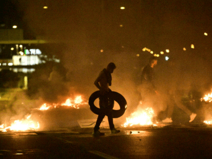 Demonstrators burn tyres during clashes with police in the Rosengard neighbourhood of Malmo, Sweden, on August 28, 2020. - The protest was sparked by the burning of a coran by members of Danish far-right party Stram Kurs during an anti-Muslim rally in Malmo earlier in the day. The party's leader …