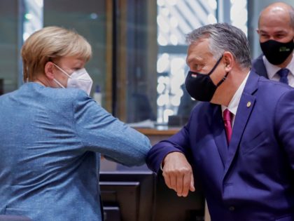 German Federal Chancellor Angela Merkel and Hungarian Prime Minister Viktor Orban (R) bump