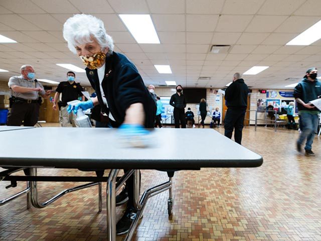 LOUISVILLE, KY - NOVEMBER 03: An election official sanitizes a surface used by voters in the polling place at Eastern High School November 3, 2020 in Louisville, Kentucky. After a record-breaking early voting turnout, Americans head to the polls on the last day to cast their vote for incumbent U.S. …