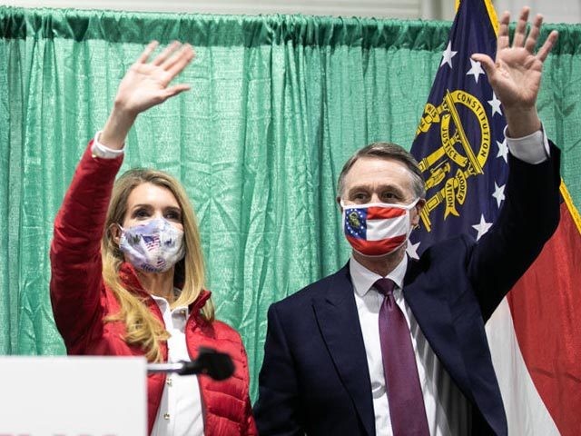 PERRY, GA - NOVEMBER 19: (R to L) U.S. Sen. David Purdue (R-GA) and Sen. Kelly Loeffler (R-GA) wave to the crowd of supporters at a "Defend the Majority" rally with Sen. Tom Cotton (R-AR) at the Georgia National Fairgrounds and Agriculture Center on November 19, 2020 in Perry, Georgia. …