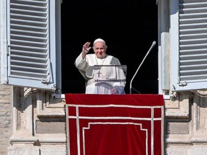 Pope Francis waves to worshippers as he arrives to deliver his weekly Angelus prayer on No