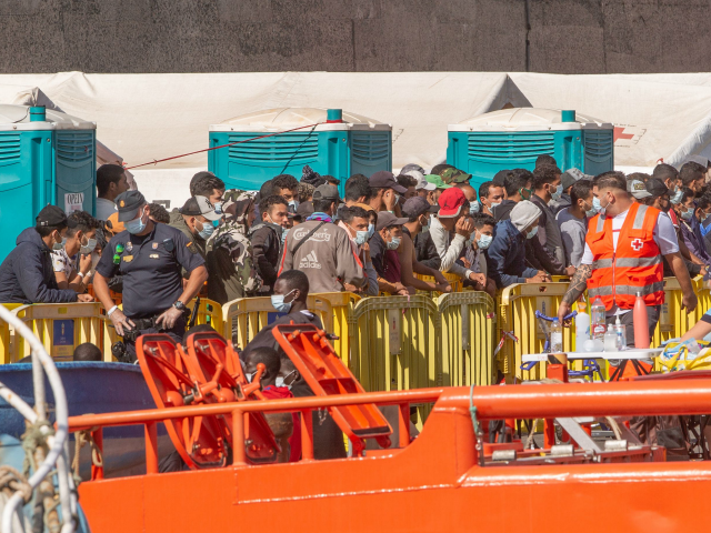 A group of migrants arrive at the Port of Arguineguin after being rescued by the Spanish coast guard in the Canary Island of Gran Canaria on November 23, 2020. - Arrivals of migrants have soared in Spain's Canary Islands with more than 18,000 arriving from Africa so far this year, …