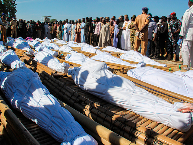Mourners attend the funeral of 43 farm workers in Zabarmari, about 20km from Maiduguri, Nigeria, on November 29, 2020 after they were killed by Boko Haram fighters in rice fields near the village of Koshobe on November 28, 2020. - The assailants tied up the agricultural workers and slit their throats in the village of Koshobe. The victims were labourers from Sokoto state in northwest Nigeria, roughly 1,000 kilometres (600 miles) away, who had travelled to the northeast to find work. (Photo by Audu Marte / AFP) (Photo by AUDU MARTE/AFP via Getty Images)