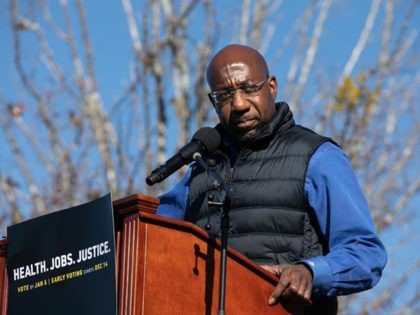 CONYERS, GA - DECEMBER 05: Democratic U.S. Senate candidate Raphael Warnock speaks to the crowd during an outdoor drive-in rally on December 5, 2020 in Conyers, Georgia. Warnock will face Republican candidate Sen. Kelly Loeffler (R-GA) in a runoff election that will take place January 5th. (Photo by Jessica McGowan/Getty …