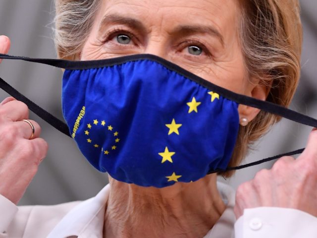 President of the European Commission Ursula von der Leyen takes of her face mask before ad