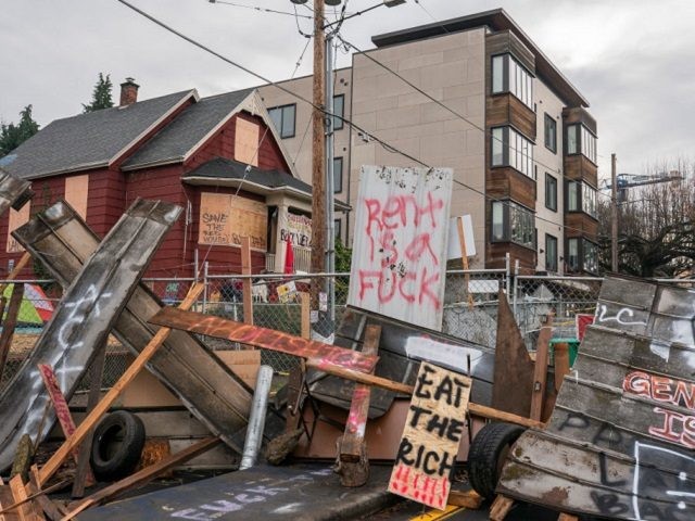 PORTLAND, OR - DECEMBER 10: (EDITOR'S NOTE: Image contains profanity). Barriers surround the Red House, whose residents are up for eviction, on December 10, 2020 in Portland, Oregon. Police and protesters clashed during an attempted eviction Tuesday morning, leading protesters to establish a barricade around the Red House. (Photo by …