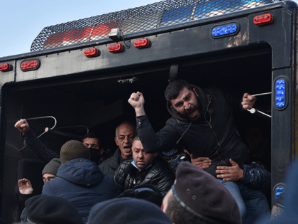 Police officers detain protesters during a rally to demand the resignation of Prime Minister Nikol Pashinyan over a controversial peace agreement with Azerbaijan that ended six weeks of war over the disputed region of Nagorno-Karabakh, in Yerevan on December 11, 2020. - Under the deal, Armenia agreed to cede three …