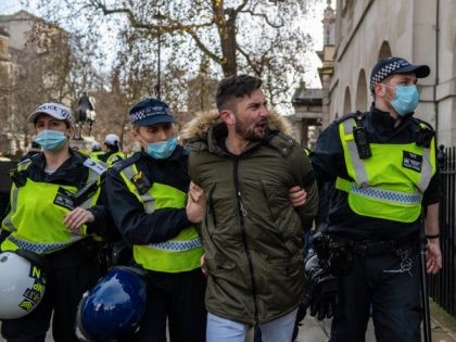 LONDON, ENGLAND - DECEMBER 19: A man is arrested during an anti lockdown protest on December 19, 2020 in London, England. With the majority of the United Kingdom now under the strictest tier 3 lockdown, Prime Minister Boris Johnson is due to hold a press conference later in the day …