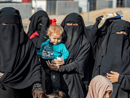 Syrian women and children, suspected of being related to Islamic State (IS) group fighters, gather at the Kurdish-run al-Hol camp, before being released to return to their homes, in the al-Hasakeh governorate in northeastern Syria, on December 21, 2020. (Photo by Delil SOULEIMAN / AFP) (Photo by DELIL SOULEIMAN/AFP via …