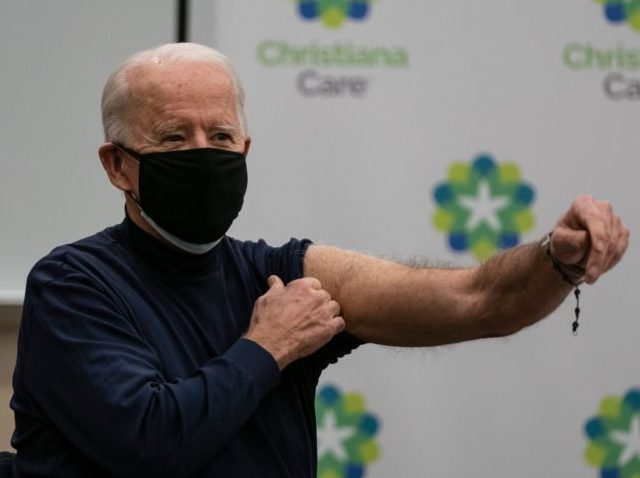 US President-elect Joe Biden holds out his arm after receiving a Covid-19 vaccination at t