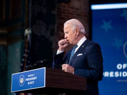 US President-Elect Joe Biden coughs while delivering remarks, before the holiday, at The Q