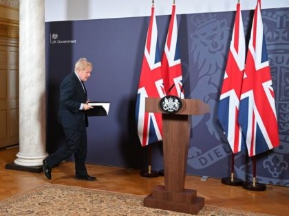 Britain's Prime Minister Boris Johnson arrives to hold a remote press conference to u