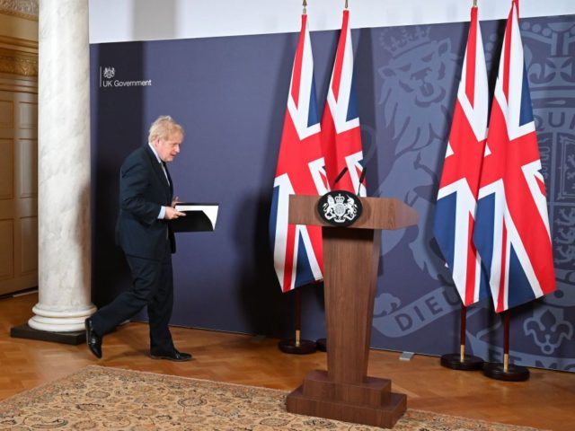 Britain's Prime Minister Boris Johnson arrives to hold a remote press conference to update the nation on the post-Brexit trade agreement, inside 10 Downing Street in central London on December 24, 2020. - Britain said on Thursday, December 24, 2020 an agreement had been secured on the country's future relationship …