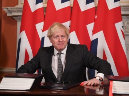 Britain's Prime Minister Boris Johnson signs the Trade and Cooperation Agreement betw