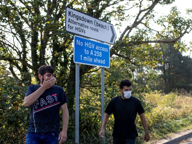 DEAL, ENGLAND - SEPTEMBER 14: Migrants make their way inland after landing on Deal beach a