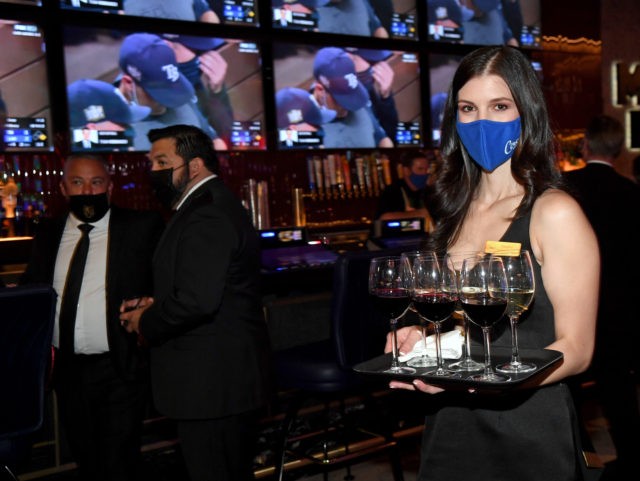 LAS VEGAS, NEVADA - OCTOBER 27: A cocktail waitress carries drinks during the grand opening of Circa Resort & Casino on October 27, 2020 in Las Vegas, Nevada. (Photo by Ethan Miller/Getty Images for Circa Resort & Casino)