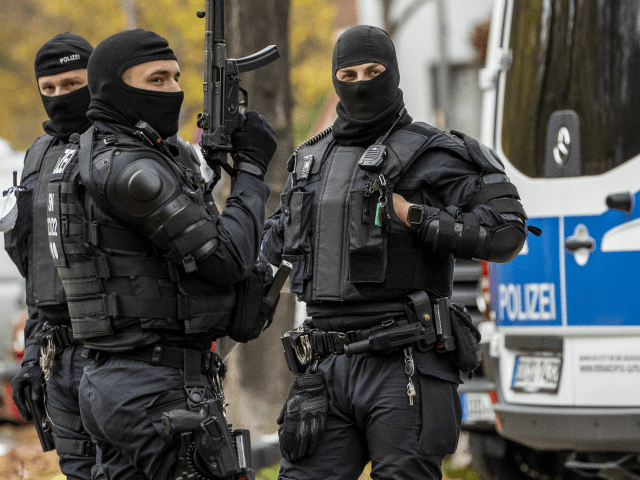 BERLIN, GERMANY - NOVEMBER 17: Heavily-armed police stand outside a street near to an apar
