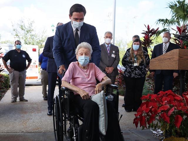POMPANO BEACH, FLORIDA - DECEMBER 16: Florida Gov. Ron DeSantis pushes Vera Leip, 88, in her wheelchair after she received a Pfizer-BioNtech COVID-19 vaccine at the John Knox Village Continuing Care Retirement Community on December 16, 2020 in Pompano Beach, Florida. The facility, one of the first in the country …