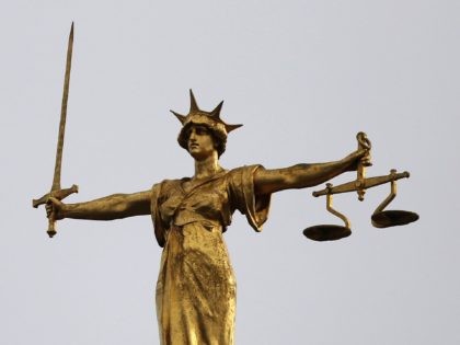LONDON, ENGLAND - FEBRUARY 16: A statue of the scales of justice stand above the Old Baile