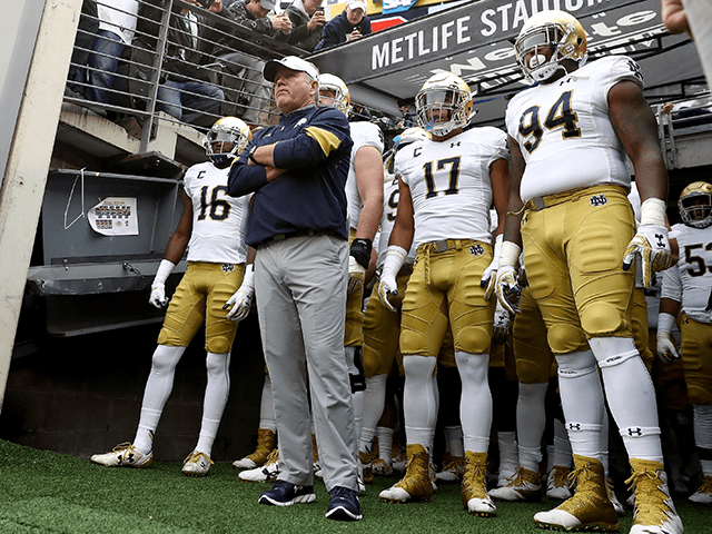 Head coach Brian Kelly of the Notre Dame Fighting Irish and his team wait to head on to the field for the start of the game against the Syracuse Orange at MetLife Stadium on October 1, 2016 in East Rutherford, New Jersey. (Photo by Elsa/Getty Images)