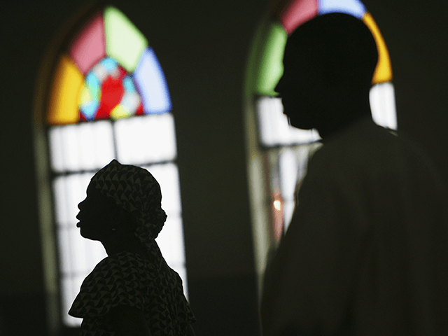 Nigerian Catholic worshippers stand during morning mass April 12, 2005 in Kano, Nigeria. Kano is part of Nigeria's primarily Muslim north, but devoted Catholic minority participates in frequent Masses in local cathedrals. Cardinal Francis Arinze of Nigeria is considered a leading contender to become pope in the aftermath of the …