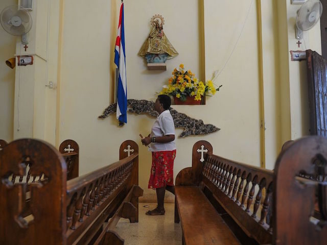 A Catholic faithful prays at Jovellanos' Church, Matanzas province, Cuba on August 9, 2017. / AFP PHOTO / YAMIL LAGE (Photo credit should read YAMIL LAGE/AFP via Getty Images)