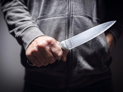 Criminal with knife weapon threatening to stab