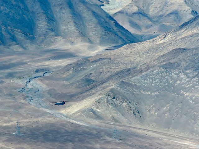 An Indian Air Force's Chinook helicopter flies over Leh, the joint capital of the union te