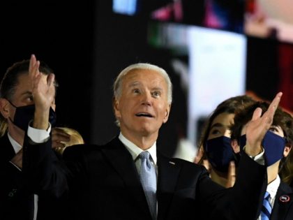 US President-elect Joe Biden with his wife Jill Biden, alongside family members, salute the crowd on stage after delivering remarks in Wilmington, Delaware, on November 7, 2020, and being declared the winner of the US presidential election. (Photo by Roberto SCHMIDT / AFP) (Photo by ROBERTO SCHMIDT/AFP via Getty Images)