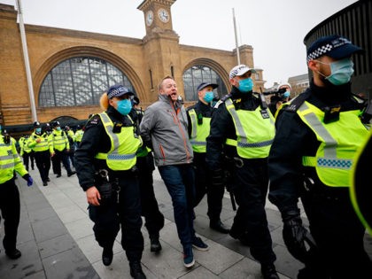 Police officers wearing protective face coverings to combat the spread of the coronavirus covid-19 take away a protester ahead of an anti-lockdown protest against government restrictions designed to control or mitigate the spread of the novel coronavirus, including the wearing of masks and lockdowns, at Kings Cross station in London …