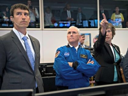 HOUSTON, TX - JUNE 07: In this handout provided by the National Aeronautics and Space Administration (NASA), U.S. Vice President Mike Pence (C), listens to NASA Deputy Chief Flight Director Holly Ridings (R), and NASA Flight Director Rick Henfling (L) during a tour of the Christopher C. Kraft Jr. Mission …