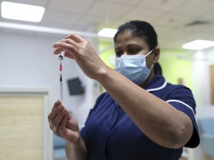 A nurse at the Royal Free Hospital, simulates the administration of the Pfizer vaccine to