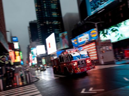 A firefighter truck drives through the almost deserted Times Square amid the Covid-19 pandemic on April 30, 2020 in New York City. (Photo by Johannes EISELE / AFP) (Photo by JOHANNES EISELE/AFP via Getty Images)
