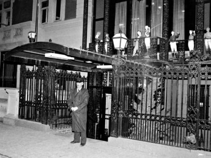 Doorman Joachim Bass stands in front of New York's '21' Club at 21 W. 52nd Street, Wednesday night, Jan. 16, 1985. It was announced that the restaurant has been sold, for the first time, for $21 million. (AP Photo/Richard Drew)