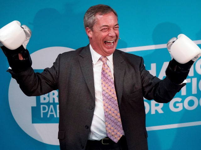 Brexit Party leader Nigel Farage poses for a photograph in boxing gloves during his visit to Gator ABC Boxing Club in Ilford, east London on November 13, 2019, during a general election campaign visit. - Britain will go to the polls on December 12 to vote in a pre-Christmas general …
