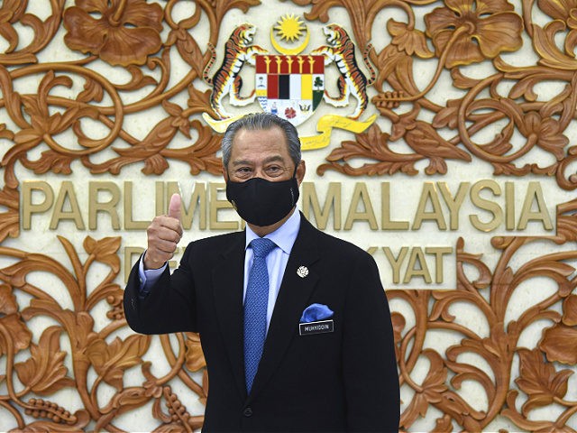 In this photo released by Malaysia's Information Ministry, Prime Minister Muhyiddin Yassin