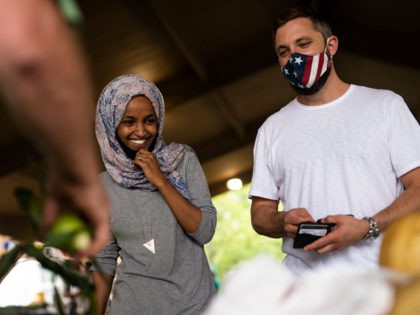 RICHFIELD, MN - AUGUST 08: Rep. Ilhan Omar (D-MN) (C) campaigns with her husband Tim Mynett (R) at the Richfield Farmers Market on August 8, 2020 in Richfield, Minnesota. Omar is hoping to retain her seat as the representative for Minnesota's 5th Congressional District in next week's primary election. (Photo …