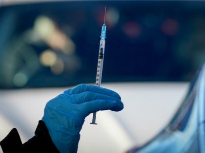 A nurse prepares to administer the Pfizer/BioNTech vaccine at a drive-thru COVID-19 vaccin