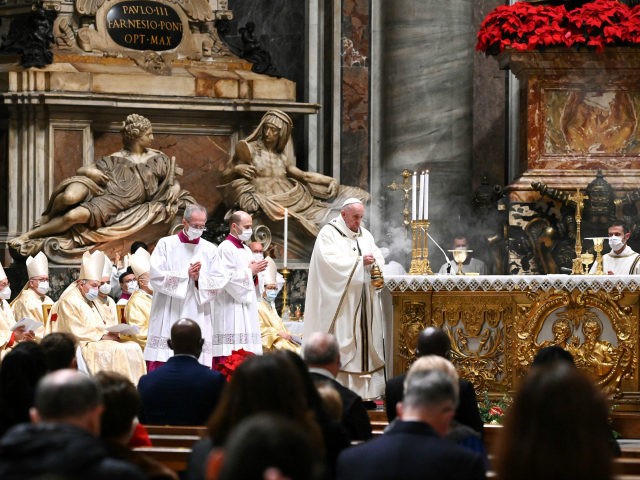 Pope Francis holds a thurible as he leads a Christmas Eve mass to mark the nativity of Jes