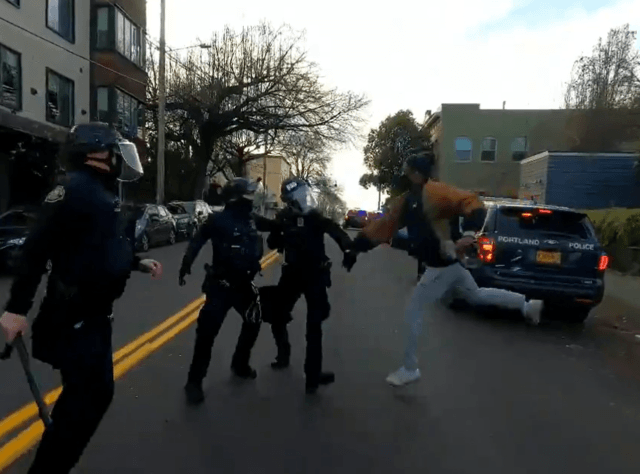 Protesters in Portland attack police officers attempting to serve an eviction on the famous "Red House." (Twitter Video Screen Capture/Andy Ngo)