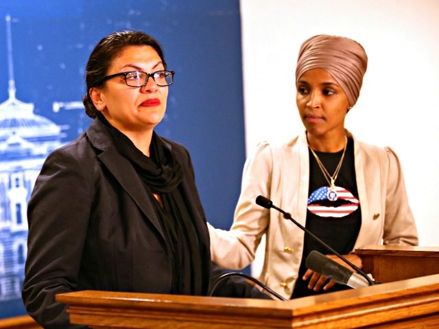 Rep. Ilhan Omar, right, (D-Minn) consoles Rep. Rashida Tlaib (D-MI) as she talk about Israel's refusal to allow them to visit the country during a news conference Monday, Aug. 19, 2019 at the State Capitol in St. Paul, Minn. (AP Photo/Jim Mone)