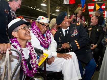 HONOLULU, HI - DECEMBER 07: Pearl Harbor survivor Ray Chavez (C) sits with his daughter Kathleen Chavez (L) and Chief Warrant Officer 4 Dorian Bozza (R) during a ceremony commemorating the 75th anniversary of the attack on Pearl Harbor at Kilo Pier on December 07, 2016 in Honolulu, Hawaii. Chavez …