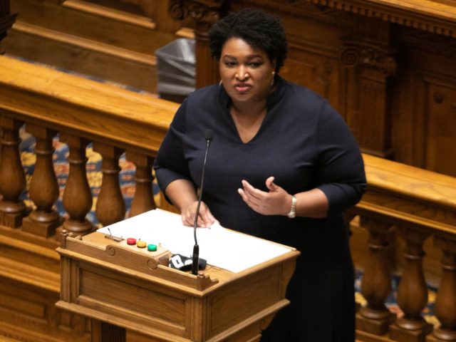 ATLANTA, GA - DECEMBER 14: Presiding officer Stacey Abrams talks to Georgia Democratic Electors gathered to cast their Electoral College votes at the Georgia State Capitol on December 14, 2020 in Atlanta, Georgia. 16 Electoral College votes were cast for President-elect Joe Biden and Vice President-elect Kamala Harris. (Photo by …