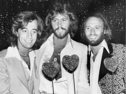 The Bee Gees, from left, Robin, Barry and Maurice Gibb, attend a party following the Hollywood premiere of "Sgt. Pepper's Lonely Hearts Club Band" on July 31, 1978. The brothers are holding sparkling papier-mache hearts given as party favors. (AP Photo/Lennox McLendon)