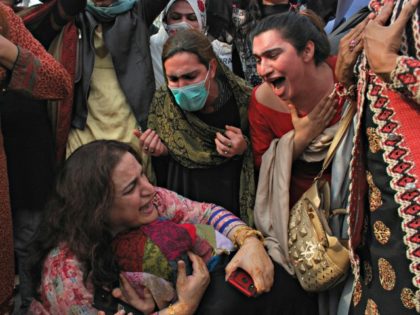 Members of the Pakistani transgender community console each other during a rally in Peshaw