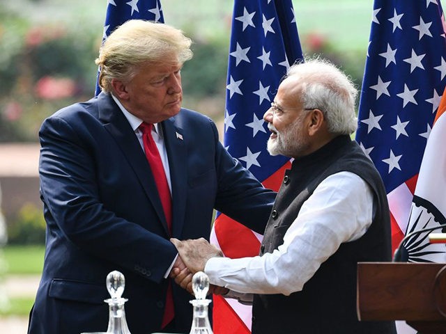 US President Donald Trump (L) shakes hands with India's Prime Minister Narendra Modi durin