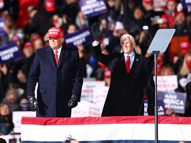 TRAVERSE CITY, MI - NOVEMBER 02: U.S. President Donald Trump (L) and U.S. Vice President Mike Pence (R) greet supporters at a rally on November 2, 2020 in Traverse City, Michigan. President Trump and former Vice President Democratic presidential nominee Joe Biden are making multiple stops in swing states ahead …